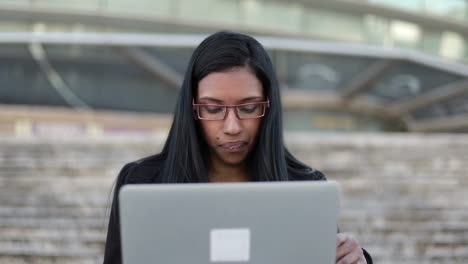 Focused-hindu-businesswoman-working-with-laptop-outdoor